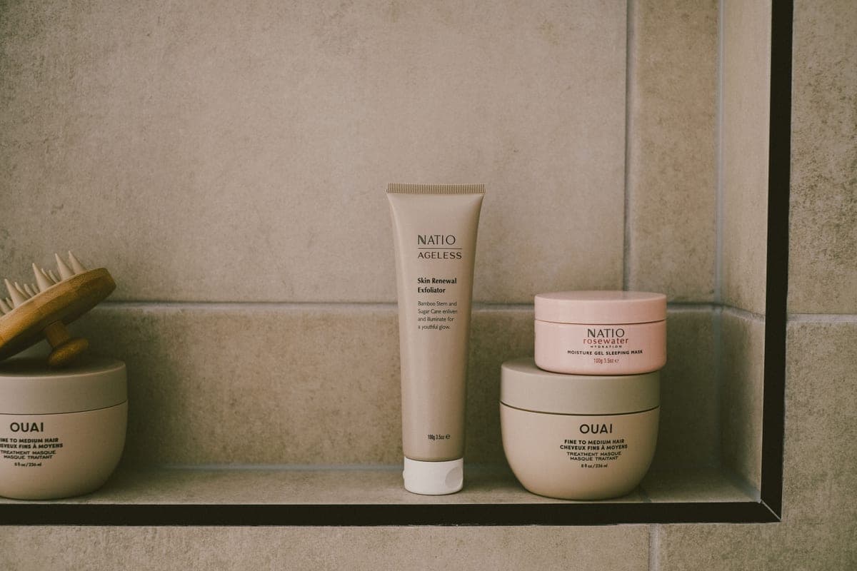 A small, tidy shelf of skincare bottles in soft daylight